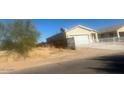 View of a single-story home featuring a two car garage and xeriscaping at 21770 W Harding St, Wittmann, AZ 85361