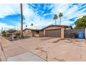 A single-story brick home featuring desert landscaping and a spacious driveway leading to a two-car garage at 2602 W Summit Pl, Chandler, AZ 85224