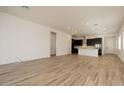 Spacious living area with wood-look floors and an open floor plan to the kitchen at 366 E Las Perlas Ln, San Tan Valley, AZ 85140