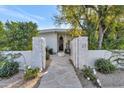 Charming gated front entrance with stone accents and a welcoming pathway at 37 Spur Cir, Scottsdale, AZ 85251