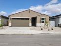 Charming single-story home with a two-car garage, desert landscaping, and a welcoming entrance at 37098 W Prado St, Maricopa, AZ 85138