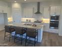 Bright kitchen features granite counters, island seating and stainless appliances at 3746 E Rochelle Cir, Mesa, AZ 85215