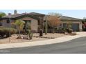 Home exterior with desert landscaping, stone accents and a neutral color palette at 3957 N 148Th Dr, Goodyear, AZ 85395