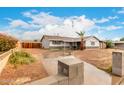 Charming single-story home with a landscaped yard and a circular driveway at 4031 N 81St Ave, Phoenix, AZ 85033