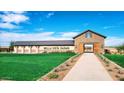 Beautiful entrance to Bella Vista Farms with manicured lawns and a stone building with the community name at 4293 E Brook Lynn Pl, San Tan Valley, AZ 85143