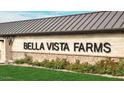 Close-up of the Bella Vista Farms sign with lush landscaping and a well-maintained lawn at 4293 E Brook Lynn Pl, San Tan Valley, AZ 85143