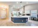 Bright kitchen featuring white cabinets, stainless steel appliances, and a large island with seating at 4332 W Carson Rd, Laveen, AZ 85339