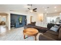 Open-concept living room featuring tile flooring, a ceiling fan, and a modern accent wall at 4332 W Carson Rd, Laveen, AZ 85339