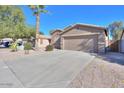 Inviting single-Gathering home featuring desert landscaping and an attached two-car garage at 43409 W Sagebrush Trl, Maricopa, AZ 85138