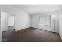 Neutral living room with carpet, window, and white walls is ready for furnishings at 461 W Holmes Ave # 383, Mesa, AZ 85210