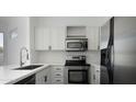 Bright kitchen features stainless steel appliances, white cabinets, and modern fixtures at 4955 E Indian School Rd # 5, Phoenix, AZ 85018