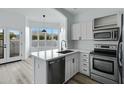 Bright kitchen features white cabinets, stainless steel appliances, and a sink with a view at 4955 E Indian School Rd # 5, Phoenix, AZ 85018