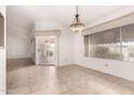 Well-lit dining area with tile floors, sliding glass door and Tiffany-style chandelier at 6200 S Championship Dr, Chandler, AZ 85249