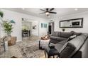 Open-concept living room featuring a gray sofa, stylish decor, and easy access to the dining area at 8345 E Oak St, Scottsdale, AZ 85257