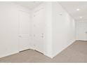 Bright hallway featuring hardwood floors and white paneled doors at 8530 W Trenton Ct, Florence, AZ 85132