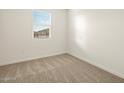 Cozy bedroom with plush carpeting, window with blinds, and a fresh coat of neutral paint at 8576 W Trenton Ct, Florence, AZ 85132