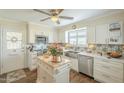 Bright kitchen featuring custom cabinets, stainless steel appliances, and wood flooring at 10417 W Deanne Dr, Sun City, AZ 85351