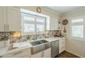 Kitchen featuring stainless steel appliances and white cabinets at 10417 W Deanne Dr, Sun City, AZ 85351