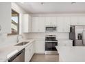 Bright kitchen featuring stainless steel appliances, white cabinets, and subway tile backsplash at 11611 W Green Dr, Youngtown, AZ 85363