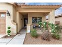 Inviting front porch with seating and well manicured desert landscaping at 1414 W Alder Rd, Queen Creek, AZ 85140