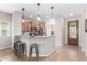 Eat-in kitchen featuring bar seating, pendant lights, and stainless steel appliances at 1414 W Alder Rd, Queen Creek, AZ 85140