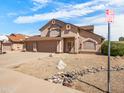 Well-maintained two-story home with xeriscaping and a three-car garage, located in a quiet neighborhood at 14317 N 78Th Dr, Peoria, AZ 85381