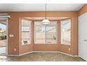 Dining area featuring a bay window that fills the space with natural light at 14527 W Marcus Dr, Surprise, AZ 85374