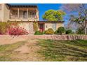 Charming two-story home featuring lush landscaping and a welcoming front porch, perfect for relaxing outdoors at 15239 W Alexandria Way, Surprise, AZ 85379