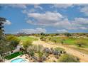 Scenic golf course view with lush green fairways and desert landscape on a sunny, partly cloudy day at 15802 N 71St St # 501, Scottsdale, AZ 85254
