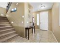 Inviting foyer with tiled floor, staircase, and decorative accents at 1708 W Seagull Ct, Chandler, AZ 85286