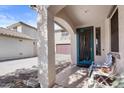 Cozy covered front porch with decorative door and seating area at 1708 W Seagull Ct, Chandler, AZ 85286