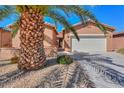 Inviting single-story home with a well-maintained front yard featuring desert landscaping and a two-car garage at 19 N Agua Fria Ln, Casa Grande, AZ 85194