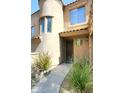 Welcoming home entrance with a curved walkway, desert landscaping, and an inviting front door at 19475 N Grayhawk Dr # 1018, Scottsdale, AZ 85255