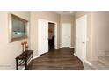 Well-lit hallway featuring wood floors, neutral paint, white doors and staircase access at 19475 N Grayhawk Dr # 1018, Scottsdale, AZ 85255