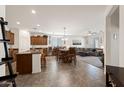 Open concept living space with a dining area, kitchen island, and a comfortable living room at 21244 E Creekside Dr, Queen Creek, AZ 85142