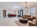 Open-concept living room with modern lighting, plantation shutters, and neutral decor at 22181 N 78Th St, Scottsdale, AZ 85255