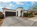 Inviting single-story home showcasing desert landscaping, two-car garage, and a quaint turret entrance at 22452 E Calle De Flores --, Queen Creek, AZ 85142