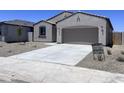 Charming single-story home featuring a neutral stucco exterior, desert landscaping and a two-car garage at 24080 W Bowker St, Buckeye, AZ 85326