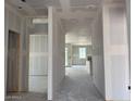 Unfinished interior showcasing an open floor plan and large windows awaiting its final touches at 24080 W Bowker St, Buckeye, AZ 85326