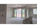 Open-concept living space under construction with expansive sliding glass doors to the backyard at 24080 W Bowker St, Buckeye, AZ 85326