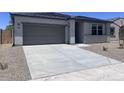 Exterior view of the home with a garage and driveway at 24088 W Bowker St, Buckeye, AZ 85326