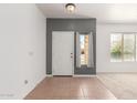Bright entryway with tile flooring, a white door, and natural light from nearby windows at 24824 W Pueblo Ave, Buckeye, AZ 85326