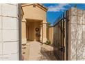 Inviting gated front entry with stone pavers leading to a charming home at 3252 E Fremont Rd, Phoenix, AZ 85042