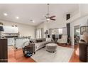 Spacious living room with hardwood floors, high ceilings, and a cozy sectional sofa at 3252 E Fremont Rd, Phoenix, AZ 85042