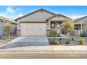 Charming single-story home featuring a two-car garage and desert landscaping in front yard at 40005 W Rio Lobo Dr, Maricopa, AZ 85138