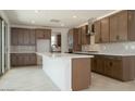 Modern kitchen features a large island, ample storage, stainless appliances, and neutral backsplash at 40101 N Alameda Dr, San Tan Valley, AZ 85140