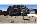 Stylish gray home featuring rock accents and desert landscaping for low maintenance in the front yard at 4329 E Brook Lynn Pl, San Tan Valley, AZ 85143