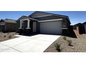 Attractive single-story home with a well-manicured front yard and a spacious two-car garage at 4329 E Brook Lynn Pl, San Tan Valley, AZ 85143