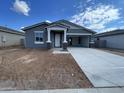Charming single-story home with a concrete driveway and covered entrance, presenting a welcoming exterior at 4329 E Brook Lynn Pl, San Tan Valley, AZ 85143