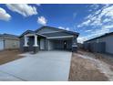 Charming single-story home with a concrete driveway and covered entrance, presenting a welcoming exterior at 4329 E Brook Lynn Pl, San Tan Valley, AZ 85143